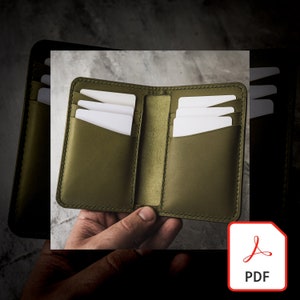 May include: A green leather wallet with multiple card slots. The wallet is open and shows the card slots.