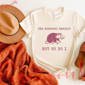 The Horrors Persist But So Do I, Sarcastic Shirt, Funny Mental Health, Meme Shirt, Raccoon Gift, RM-350