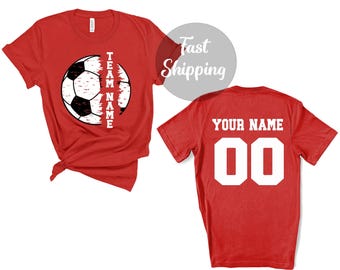 May include: Two red t-shirts, one with a soccer ball graphic and the text "TEAM NAME" and the other with the text "YOUR NAME" and the number "00".
