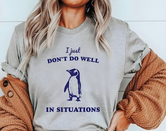 May include: Grey t-shirt with a penguin graphic and the text "I just don't do well in situations".