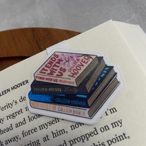 May include: A sticker featuring a stack of four books by Colleen Hoover. The books are "It Ends With Us", "Verity", "Ugly Love", and "November 9".