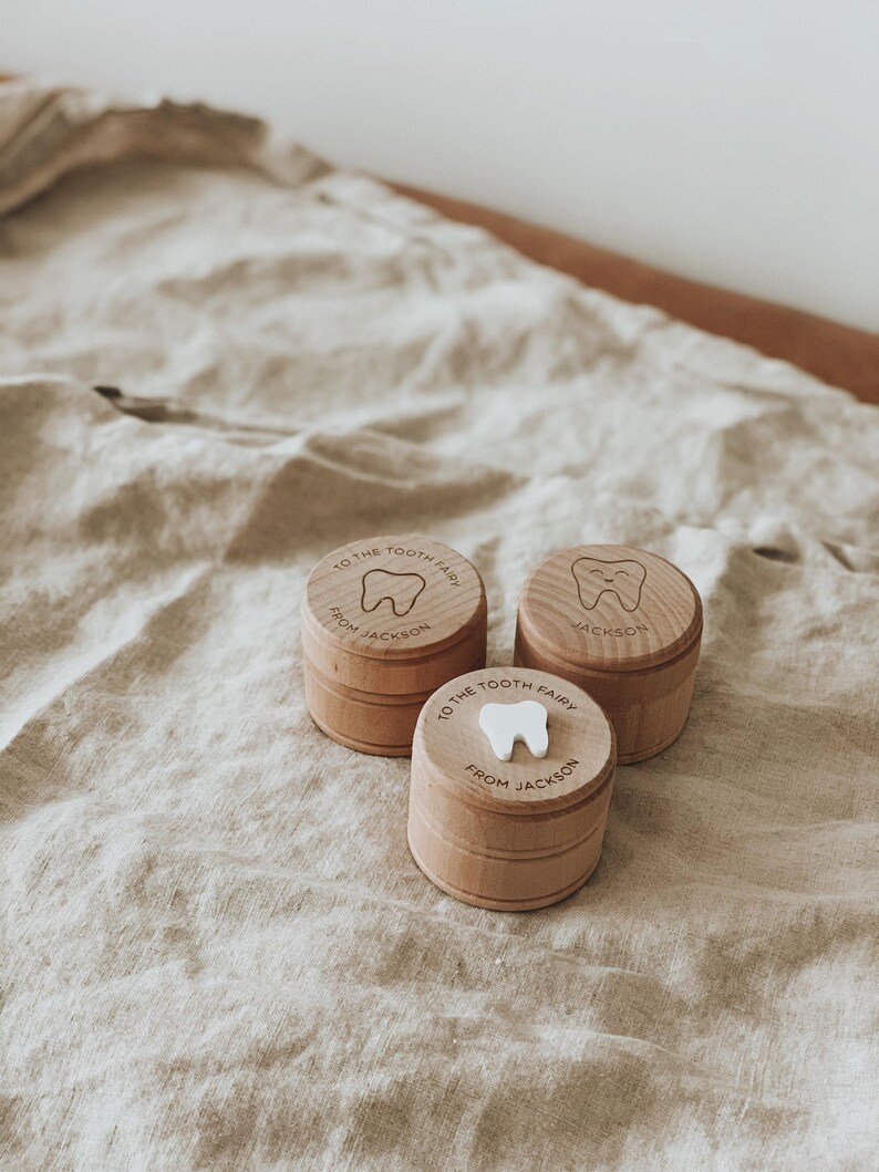 May include: Three wooden tooth fairy boxes with a tooth design and the text "To the Tooth Fairy from Jackson" on each box.