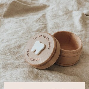 May include: A wooden tooth fairy box with a white tooth cutout and the text "To the Tooth Fairy From Jackson".