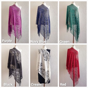 May include: Six different colored lace shawls with floral patterns. The shawls are displayed on mannequins and are available in purple, navy blue, green, black, cream, and red.