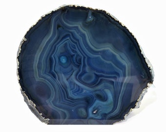 May include: A blue agate slice with a silver trim. The agate has a swirling pattern of blue and white.