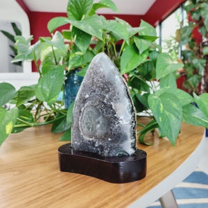 Raw Grey Amethyst with staclatite  from the mines of Brazil. Very much in it's natural raw state, this unique collector's piece comes with a customised wooden base. stands about 6inches tall.