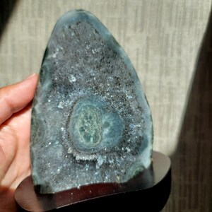 Raw Grey Amethyst with staclatite  from the mines of Brazil. Very much in it's natural raw state, this unique collector's piece comes with a customised wooden base. stands about 6inches tall.