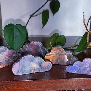 May include: Five iridescent labradorite crystal cloud sculptures in various shades of purple, blue, and gold.