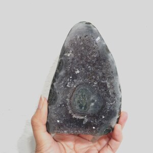 Raw Grey Amethyst with staclatite  from the mines of Brazil. Very much in it's natural raw state, this unique collector's piece comes with a customised wooden base. stands about 6inches tall.
