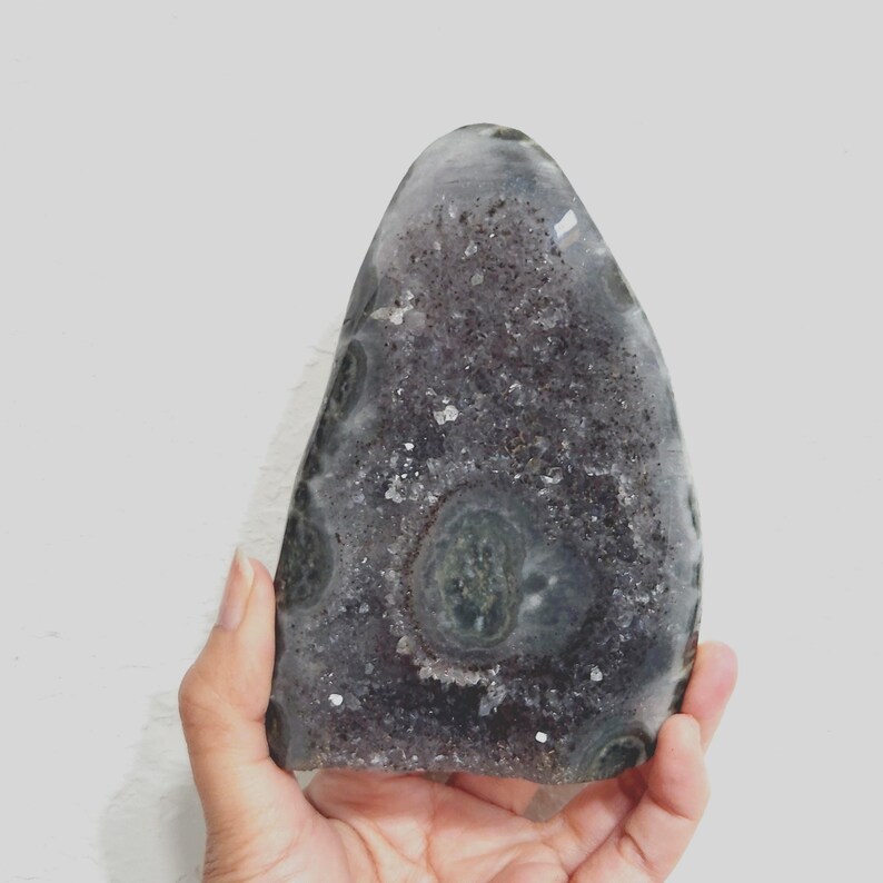 Raw Grey Amethyst with staclatite  from the mines of Brazil. Very much in it's natural raw state, this unique collector's piece comes with a customised wooden base. stands about 6inches tall.