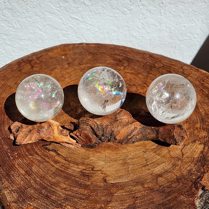 Lemurian Quartz sphere filled with strong rainbows. Clear and high quality quartz sphere that will bring the healing properties of this Master Healer. Measuring approximately 2.2" across, sold without stand. Perfect for your crystal collection.