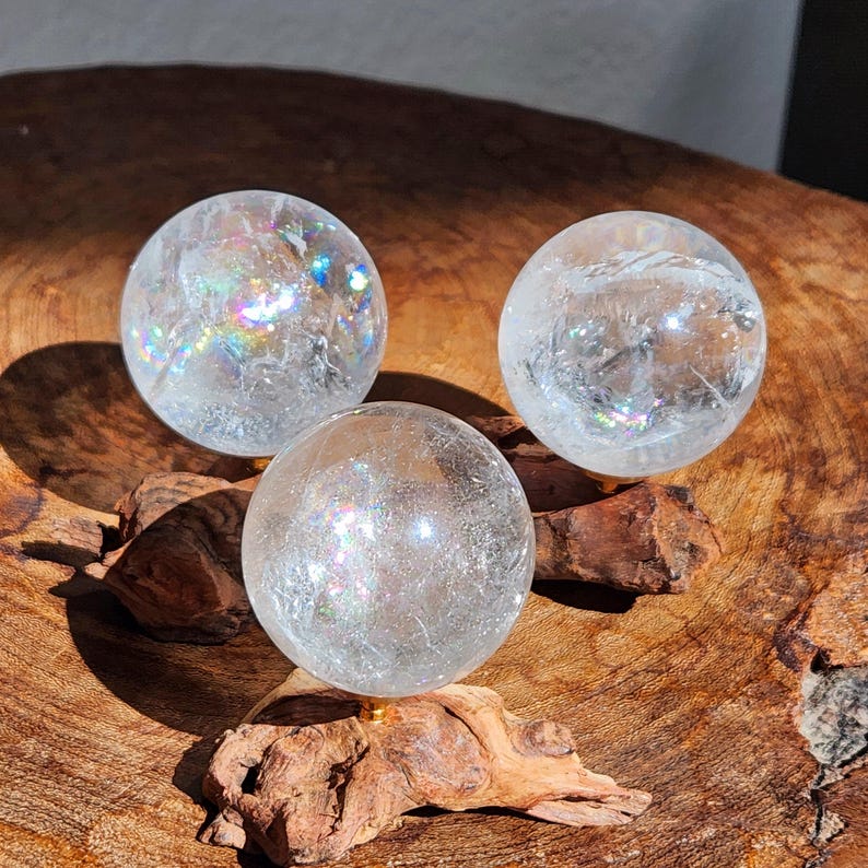 Lemurian Quartz sphere filled with strong rainbows. Clear and high quality quartz sphere that will bring the healing properties of this Master Healer. Measuring approximately 2.2" across, sold without stand. Perfect for your crystal collection.