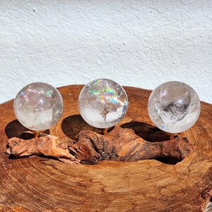 Lemurian Quartz sphere filled with strong rainbows. Clear and high quality quartz sphere that will bring the healing properties of this Master Healer. Measuring approximately 2.2" across, sold without stand. Perfect for your crystal collection.