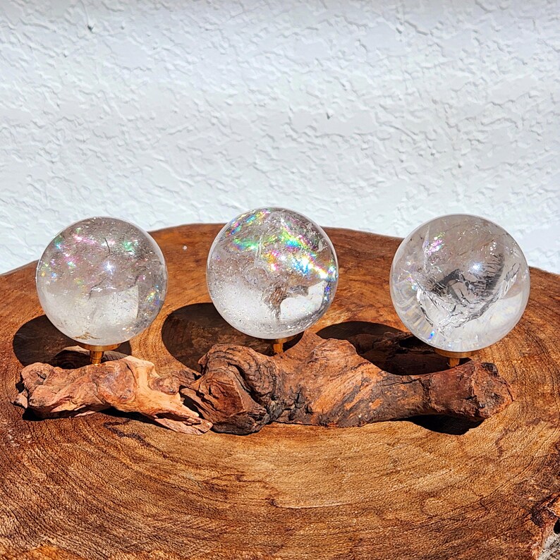Lemurian Quartz sphere filled with strong rainbows. Clear and high quality quartz sphere that will bring the healing properties of this Master Healer. Measuring approximately 2.2" across, sold without stand. Perfect for your crystal collection.