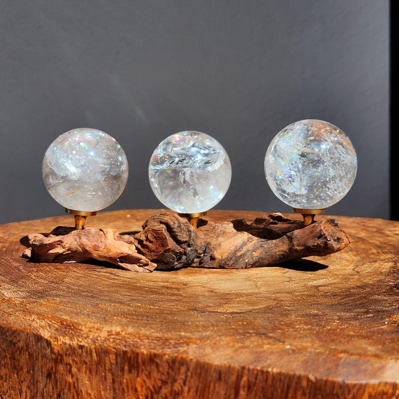 Lemurian Quartz sphere filled with strong rainbows. Clear and high quality quartz sphere that will bring the healing properties of this Master Healer. Measuring approximately 2.2" across, sold without stand. Perfect for your crystal collection.