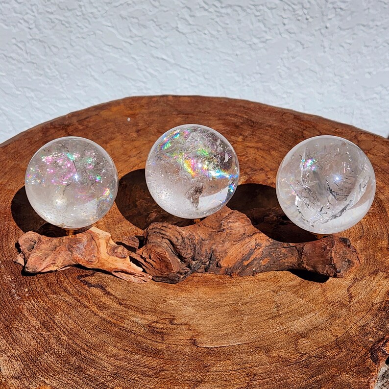 Lemurian Quartz sphere filled with strong rainbows. Clear and high quality quartz sphere that will bring the healing properties of this Master Healer. Measuring approximately 2.2" across, sold without stand. Perfect for your crystal collection.