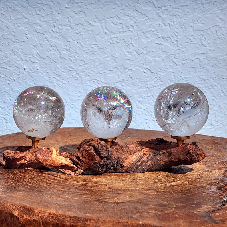 Lemurian Quartz sphere filled with strong rainbows. Clear and high quality quartz sphere that will bring the healing properties of this Master Healer. Measuring approximately 2.2" across, sold without stand. Perfect for your crystal collection.