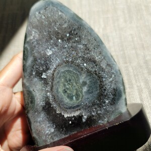 Raw Grey Amethyst with staclatite  from the mines of Brazil. Very much in it's natural raw state, this unique collector's piece comes with a customised wooden base. stands about 6inches tall.