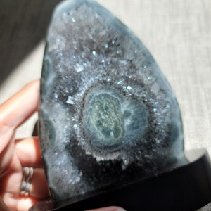 Raw Grey Amethyst with staclatite  from the mines of Brazil. Very much in it's natural raw state, this unique collector's piece comes with a customised wooden base. stands about 6inches tall.