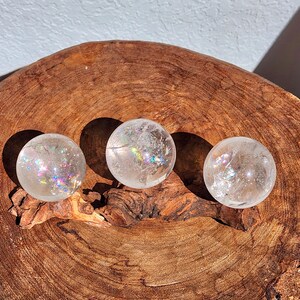 Lemurian Quartz sphere filled with strong rainbows. Clear and high quality quartz sphere that will bring the healing properties of this Master Healer. Measuring approximately 2.2" across, sold without stand. Perfect for your crystal collection.