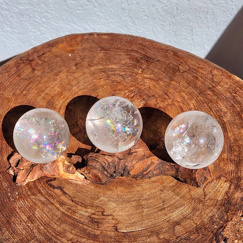 Lemurian Quartz sphere filled with strong rainbows. Clear and high quality quartz sphere that will bring the healing properties of this Master Healer. Measuring approximately 2.2" across, sold without stand. Perfect for your crystal collection.