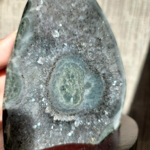 Raw Grey Amethyst with staclatite  from the mines of Brazil. Very much in it's natural raw state, this unique collector's piece comes with a customised wooden base. stands about 6inches tall.