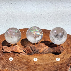 Lemurian Quartz sphere filled with strong rainbows. Clear and high quality quartz sphere that will bring the healing properties of this Master Healer. Measuring approximately 2.2" across, sold without stand. Perfect for your crystal collection.