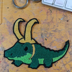 A cute croc with a hat embroidery file pack