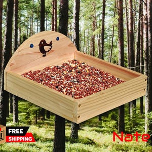 May include: A wooden bird feeder with a curved roof and a bird silhouette design. The feeder is filled with birdseed and is shown in a forest setting.