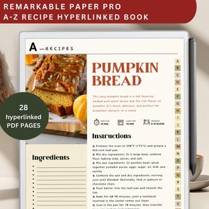 May include: A digital recipe book on a tablet, featuring a pumpkin bread recipe. The screen displays the title "Pumpkin Bread" with instructions and ingredients. The book has 28 hyperlinked PDF pages. A stylus and a cup are on the side.