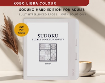 May include: A white e-reader with a black and white Sudoku puzzle book displayed on the screen. The screen reads "Sudoku Puzzle Book for Adults" and "Hard". The e-reader has a Kobo logo on the bottom right corner.
