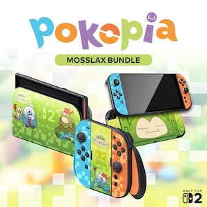K&ouml;nnte beinhalten: Ein Nintendo Switch Mosslax Bundle mit gr&uuml;nen, blauen und orangen Farbt&ouml;nen. Das Bundle enth&auml;lt eine Konsole, Controller und eine Dockingstation, alle mit Charaktergrafiken und dem Text "Pokopia" und "Mosslax Bundle" verziert.