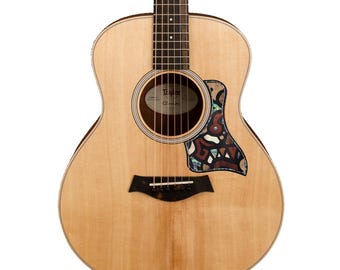 May include: A light-colored acoustic guitar featuring a dark wood fretboard, a circular sound hole, and a decorative pickguard with an intricate mosaic pattern. The text "Guitar not included" is visible in the upper right corner of the image.