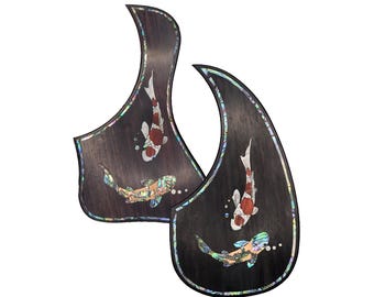 May include: Two dark wood guitar pickguards, one Taylor shape and one teardrop shape, featuring inlaid koi fish designs with iridescent abalone shell accents and the text Taylor & Teardrop Shape Koi Design at the top of the image.
