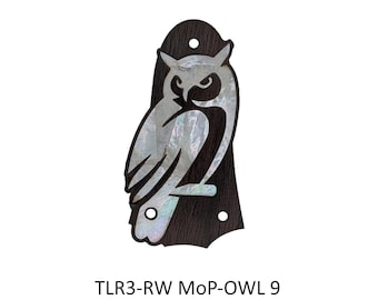 May include: A dark brown wooden guitar truss rod cover featuring an iridescent mother-of-pearl owl inlay. The piece has three pre-drilled mounting holes and the text TLR3-RW MoP-OWL 9 is printed in black below the object on a white background.