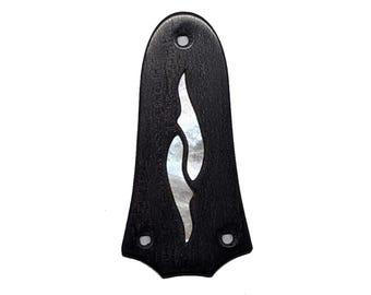 May include: A black ebony guitar headstock overlay with a pearlescent inlay in a flame design. The overlay has three pre-drilled holes and the text "Example of Ebony" and "TLR3-EB 814CE".