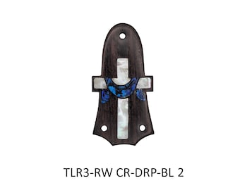 May include: A dark brown wooden guitar truss rod cover featuring a white mother-of-pearl cross inlay and a blue iridescent crescent-shaped accent. The piece has three pre-drilled mounting holes and the text TLR3-RW CR-DRP-BL 2 printed below it.