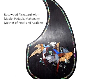May include: A dark rosewood pickguard with inlaid birds and floral designs. The pickguard features maple, padauk, mahogany, mother of pearl, and abalone. The text "The Lovebirds" is displayed at the top.