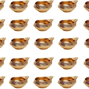 May include: Twenty-four gold-colored metal diya oil lamps arranged in four rows of six. Each diya has a decorative design and a small spout for pouring oil.