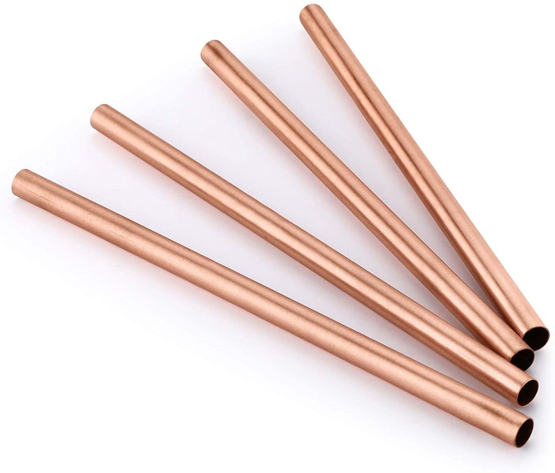 May include: Four rose gold reusable metal drinking straws. The straws are made of stainless steel and are a popular eco-friendly alternative to plastic straws.