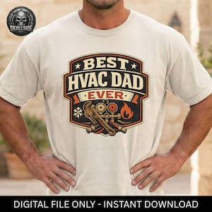May include: A cream-colored t-shirt featuring a graphic design with the text BEST HVAC DAD EVER. The design includes illustrations of a pipe wrench, pressure gauges, and a flame icon, all enclosed within a dark-bordered shield-shaped emblem.