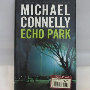 May include: A hardback book titled Echo Park by Michael Connelly. The dark blue cover features white text for the author's name and lime green text for the title. The background shows a nighttime park scene with trees and a red bargain price sticker.