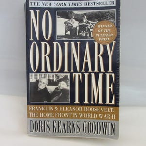 May include: A hardback book titled No Ordinary Time by Doris Kearns Goodwin. The dark blue cover features white text, a black and white photograph of Franklin and Eleanor Roosevelt, and a gold circular badge stating Winner of the Pulitzer Prize.