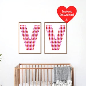 May include: Two framed prints, each showing the letter 'V' made of red and pink hearts. The prints are in wooden frames and are hung on a white wall. A red heart graphic with 'Instant Download' is in the top right corner.