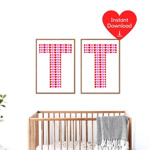 May include: Two framed prints, each featuring the letter 'T' formed from red and pink hearts. The prints are in wooden frames and are displayed on a white wall. A red heart graphic with 'Instant Download' is in the upper right corner.