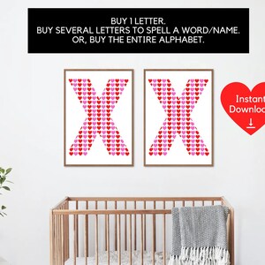 May include: Two framed prints of the letter "X", each made of red and pink hearts on a white background. The prints are displayed on a white wall above a wooden cot. Text above reads: "BUY 1 LETTER. BUY SEVERAL LETTERS TO SPELL A WORD/NAME. OR, BUY THE ENTIRE ALPHABET."