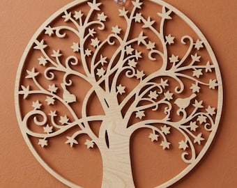 May include: A round, wooden wall art piece featuring a tree design. The tree has a detailed cutout with leaves, birds, and swirling branches. The natural wood color contrasts against the orange background. A clear plastic disc is at the top.