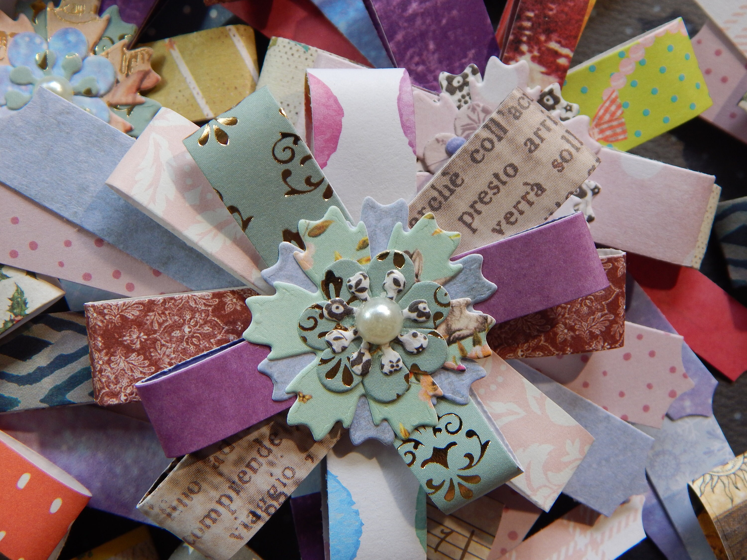 Handmade Paper Embellishment Layered Flower Mounted on a Die Cut Background. Papercraft