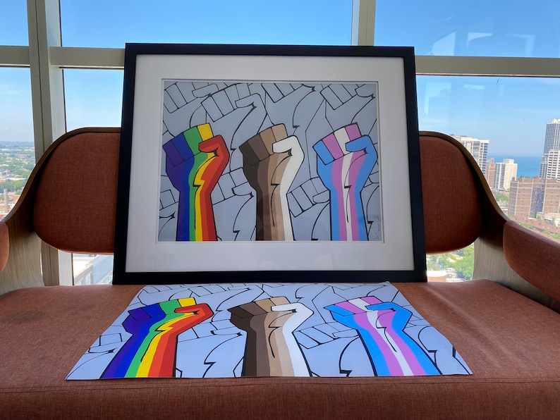 May include: Four raised fists, each painted with a different color scheme representing different identities, are shown against a background of repeated fists. The fists are painted in rainbow, brown, white and blue with a pink stripe.