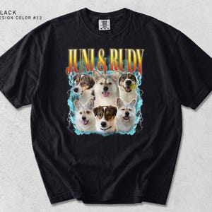 May include: A black short-sleeve t-shirt featuring a graphic print of five dogs with the text JUNI & RUDY in yellow and orange gradient lettering. The design includes blue lightning effects surrounding the dogs on a dark background.